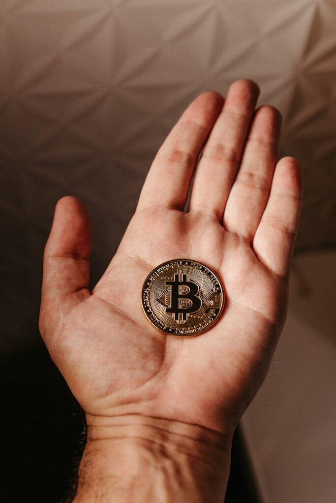 Close Up of Bitcoin Crypto Currency Coin on Hand