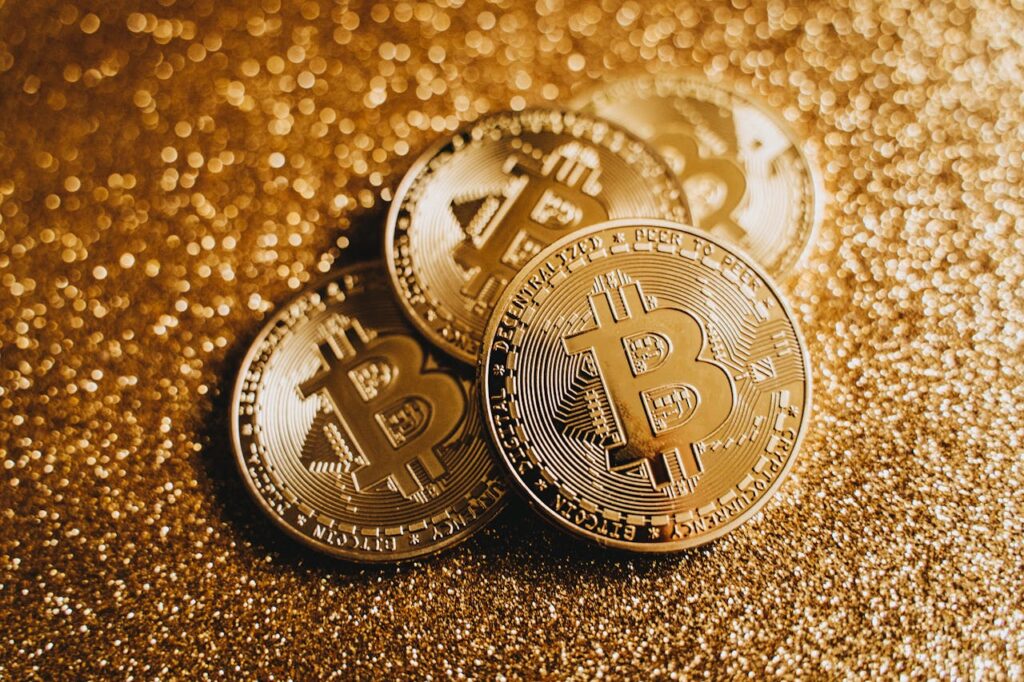 Close-up of Bitcoin Coins in Golden Glitter Background 