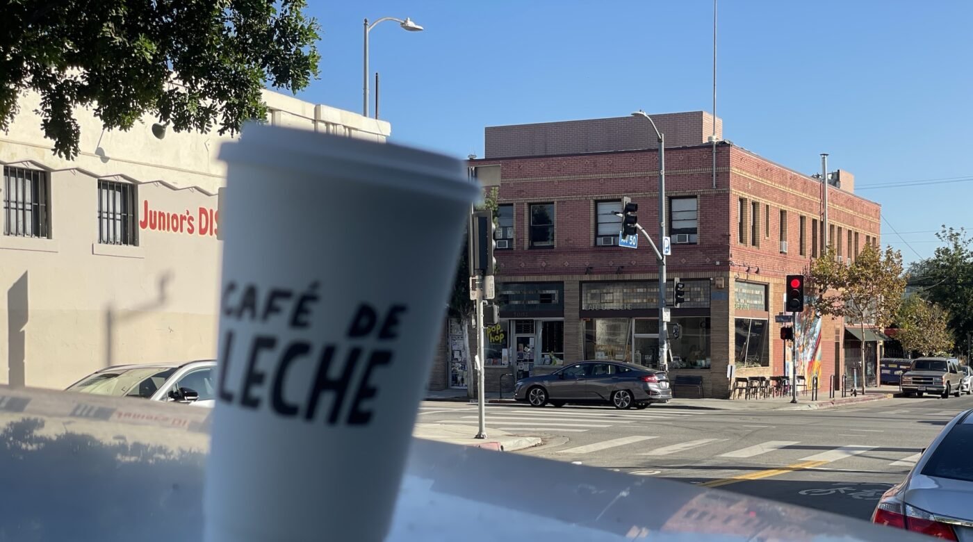 Cafe-de-Leche-cup-and-storefront-1-1